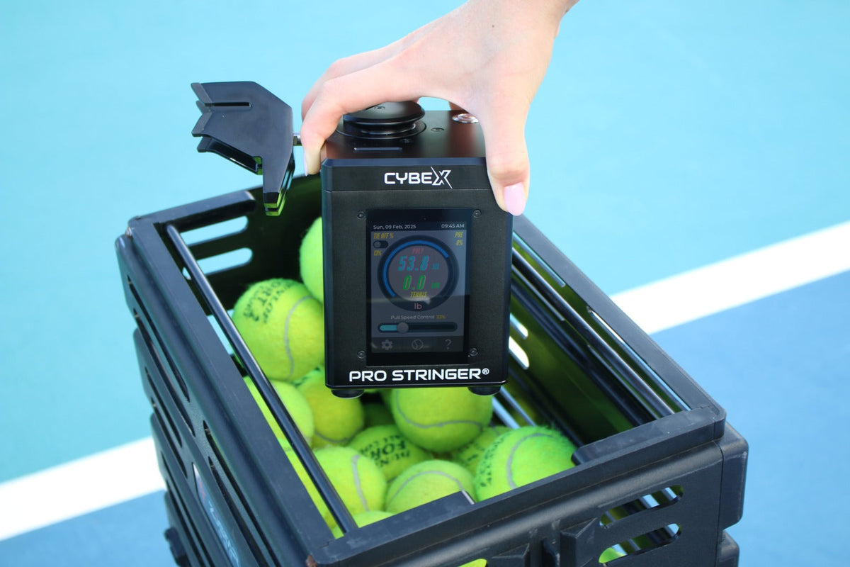 Pro Stringer CybeX electronic tennis stringing machine inside a tennis ball basket.
