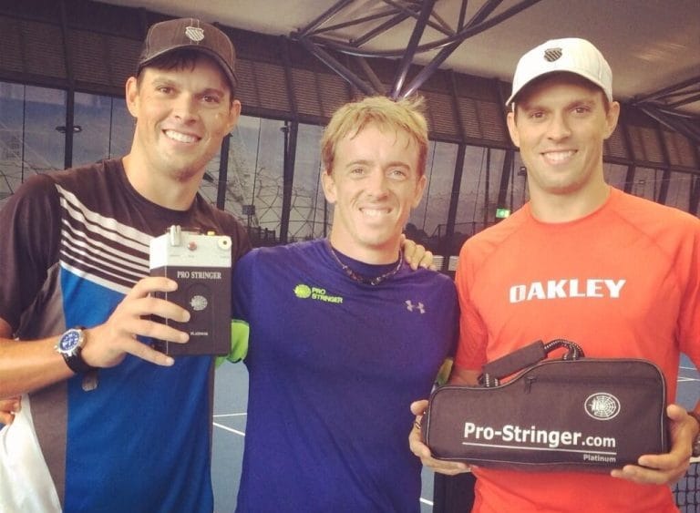 Pro Stringer founder Rubin Statham with his team holding the portable electronic tennis stringing machine.