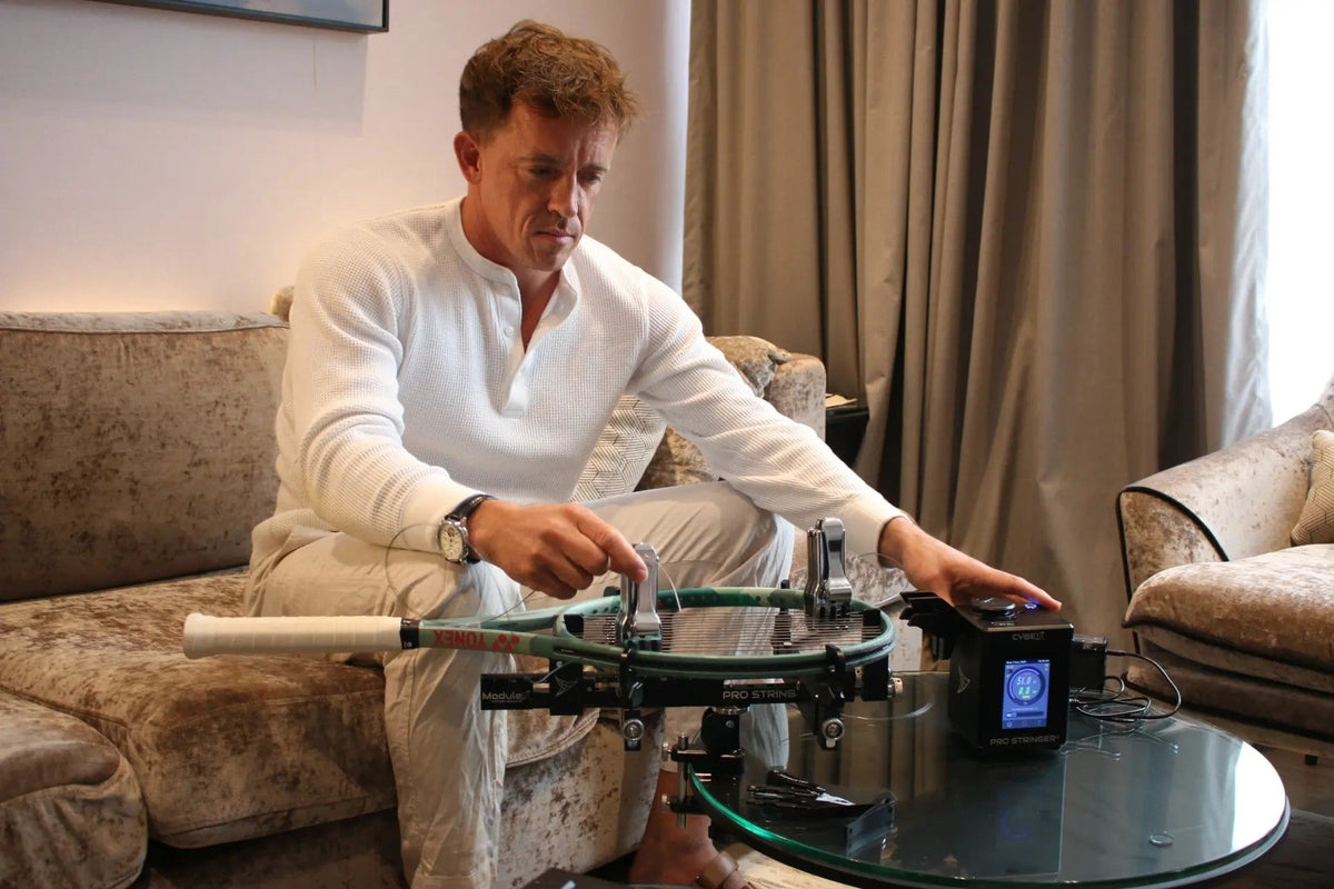 Pro Stringer founder Rubin Statham stringing a racquet on the Pro Stringer CybeX