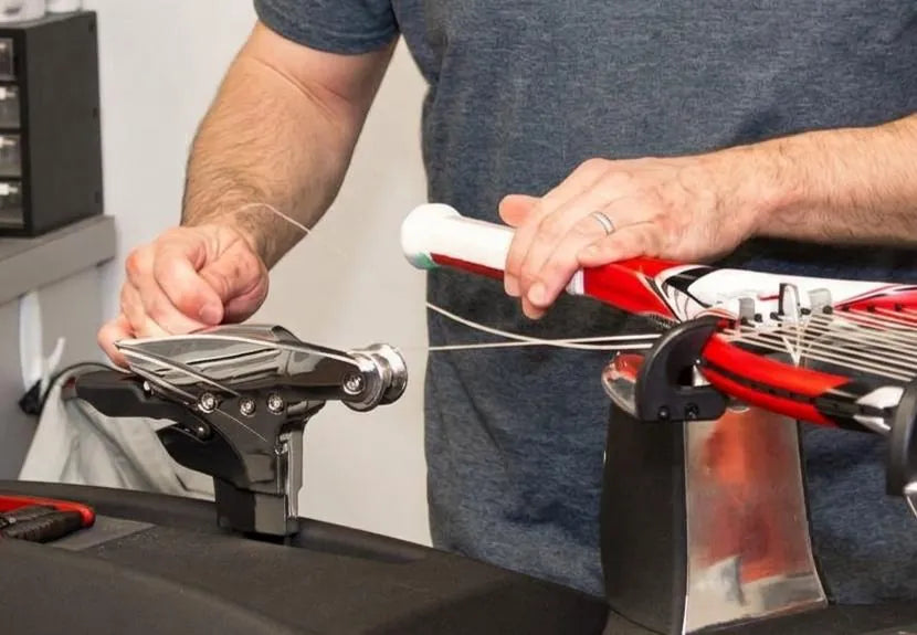 Conventional stringing machine with string running from the racquet to a distant tension head